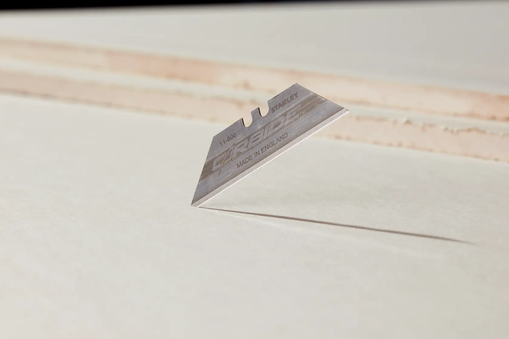 STANLEY 0-11-800 utility knife blade standing on edge, close-up with white background.