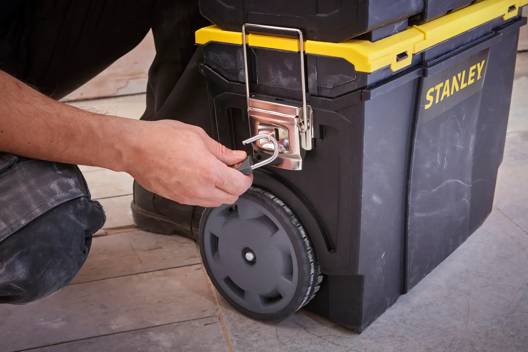 STANLEY 1-70-326 tool chest with yellow lid, lock detail, being secured, front angle photo.