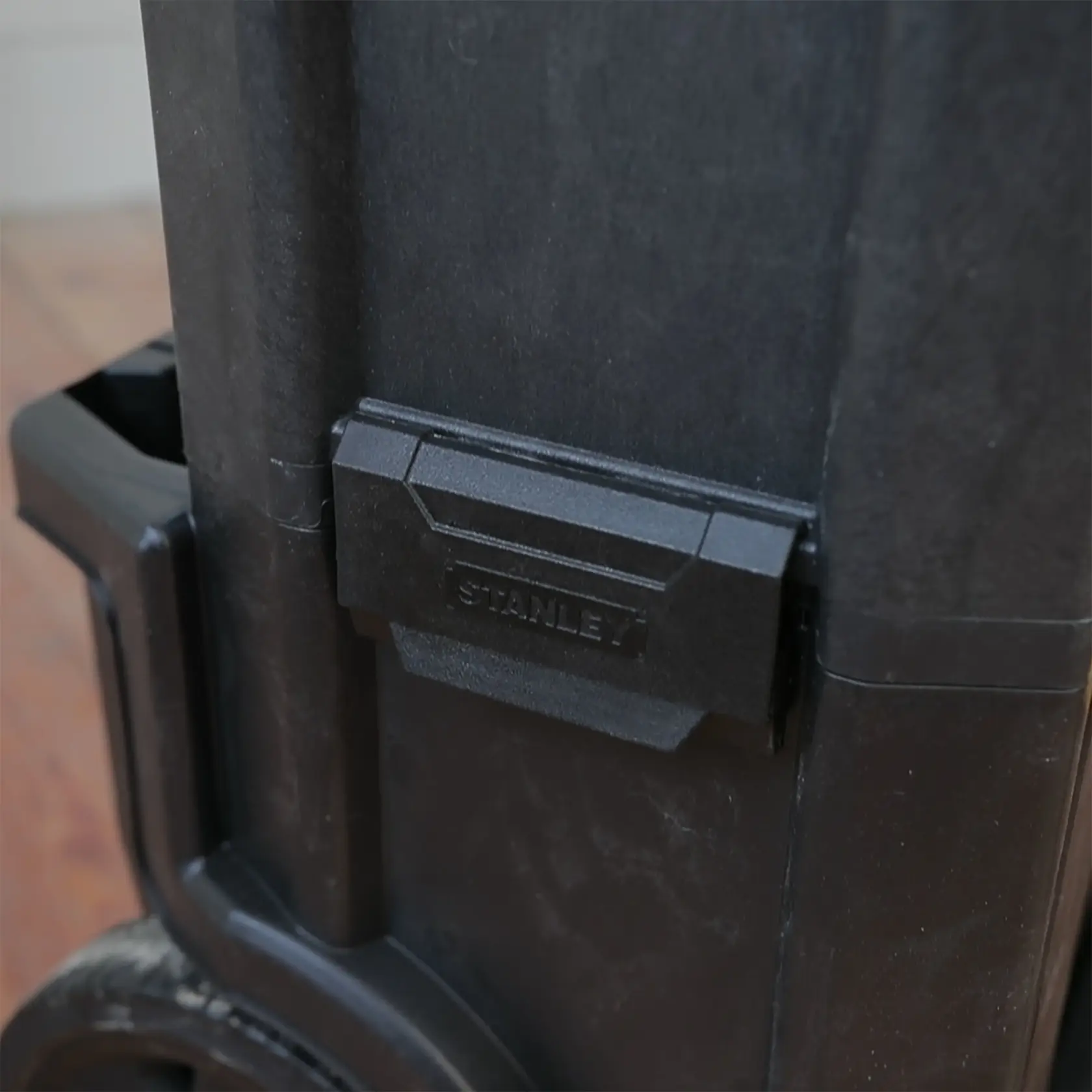 STANLEY 1-79-206 tool box latch close-up, black plastic, front angle, photography product.