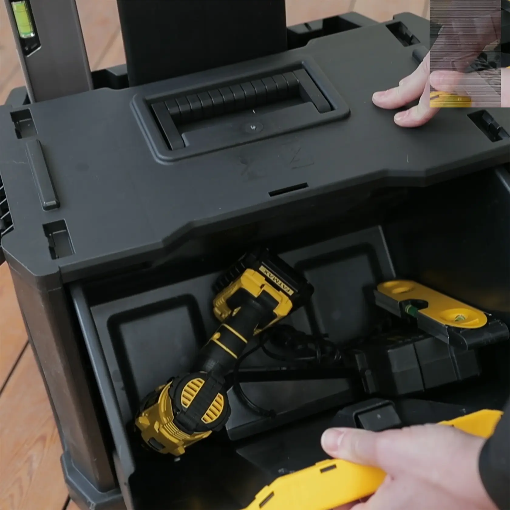 STANLEY 1-79-206 tool storage box partially opened, showing yellow and black tools inside.