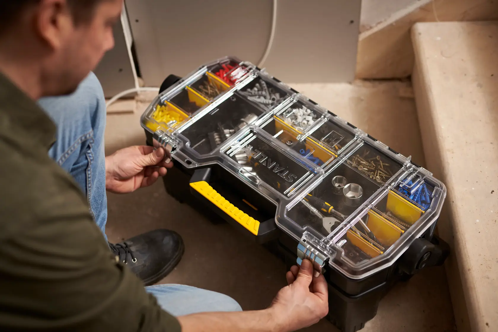 STANLEY 1-97-514 organizer box with clear lid, yellow handle, compartments with hardware, used on site.