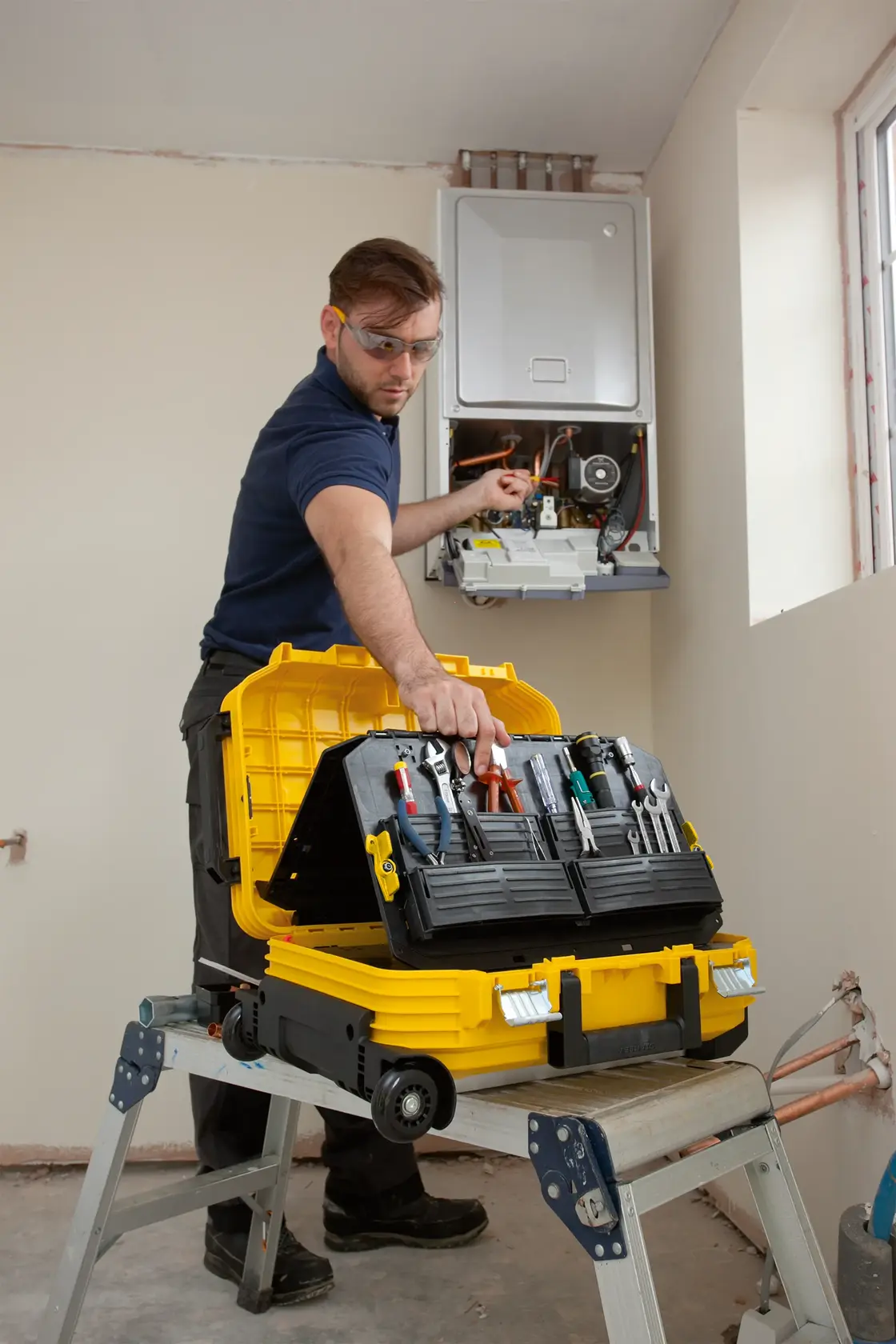 STANLEY FMST1-71943 tool box open with tools, used by technician in home maintenance setting.