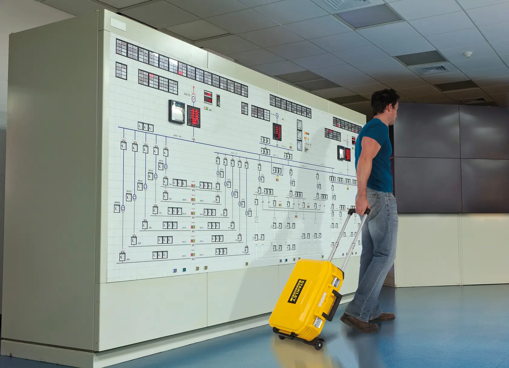 STANLEY FMST1-71943 yellow rolling tool case with handle, indoor control room setting.