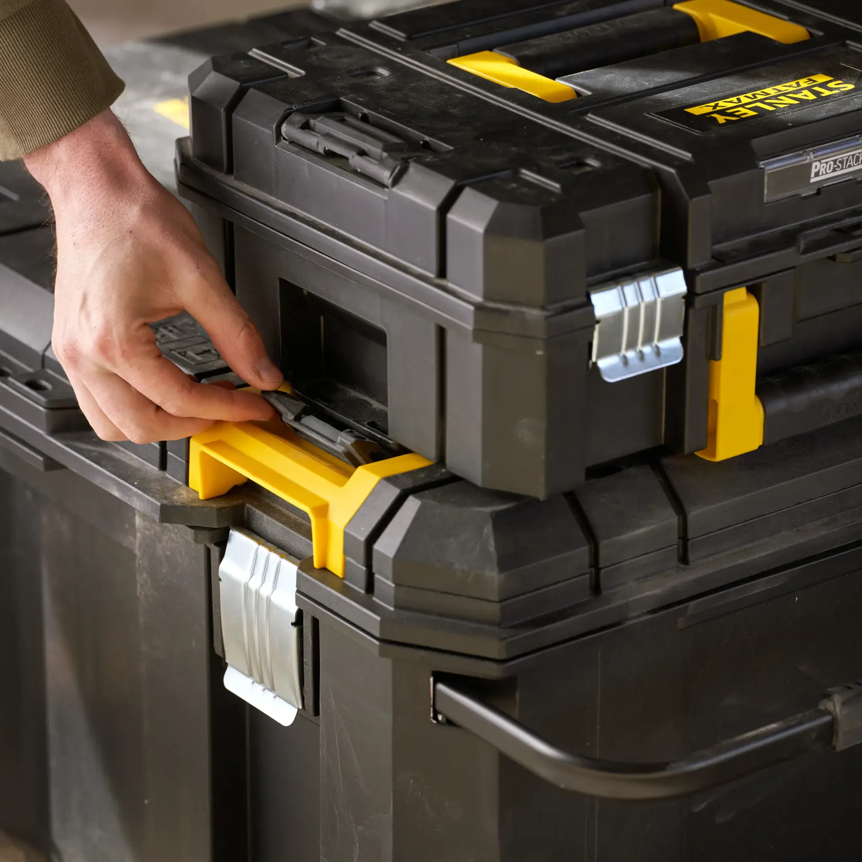STANLEY FMST17870-1 black and yellow tool storage box, close-up showing latch detail, photography