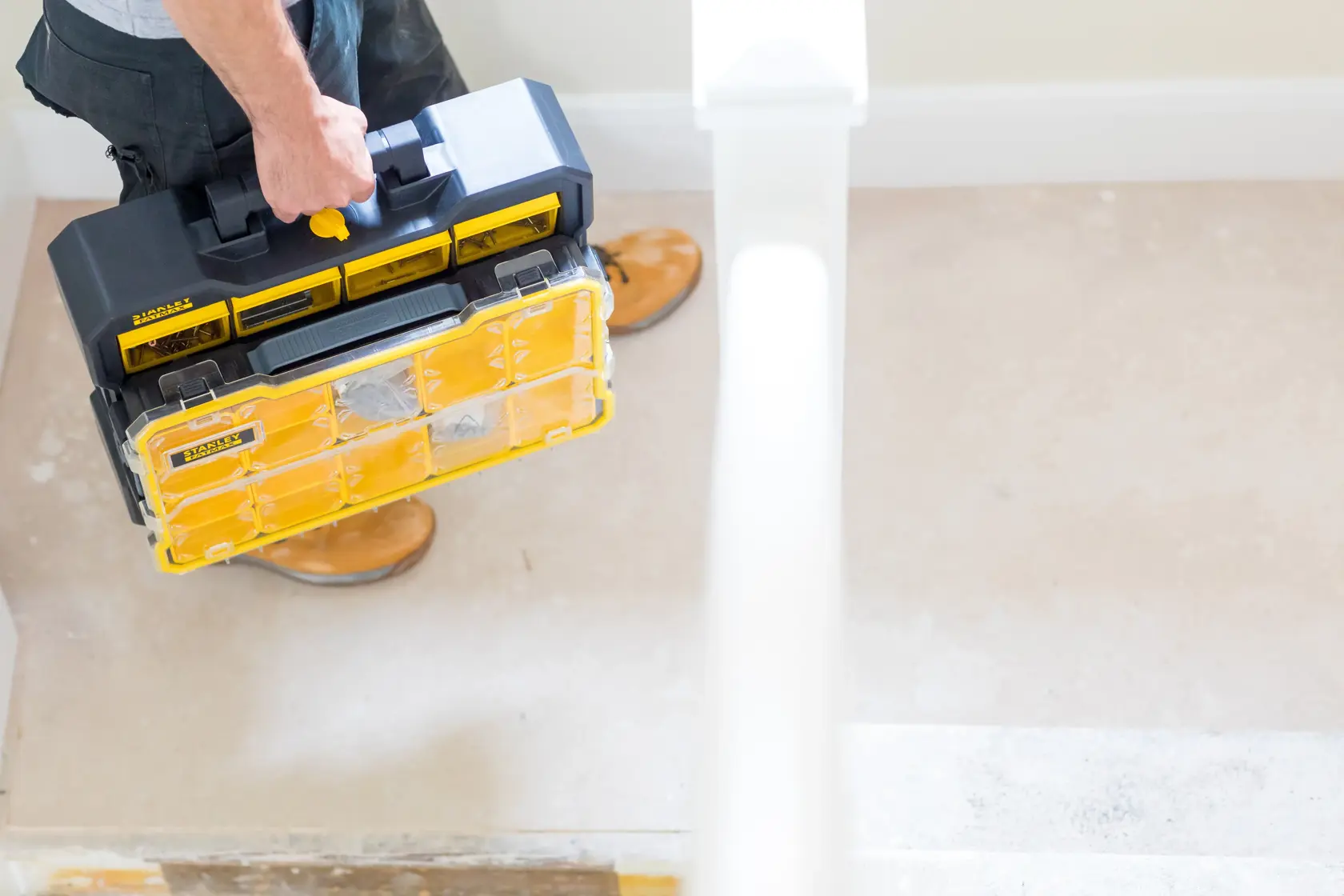 STANLEY FMST81077-1 organizer with transparent yellow compartments carried by a person indoors.