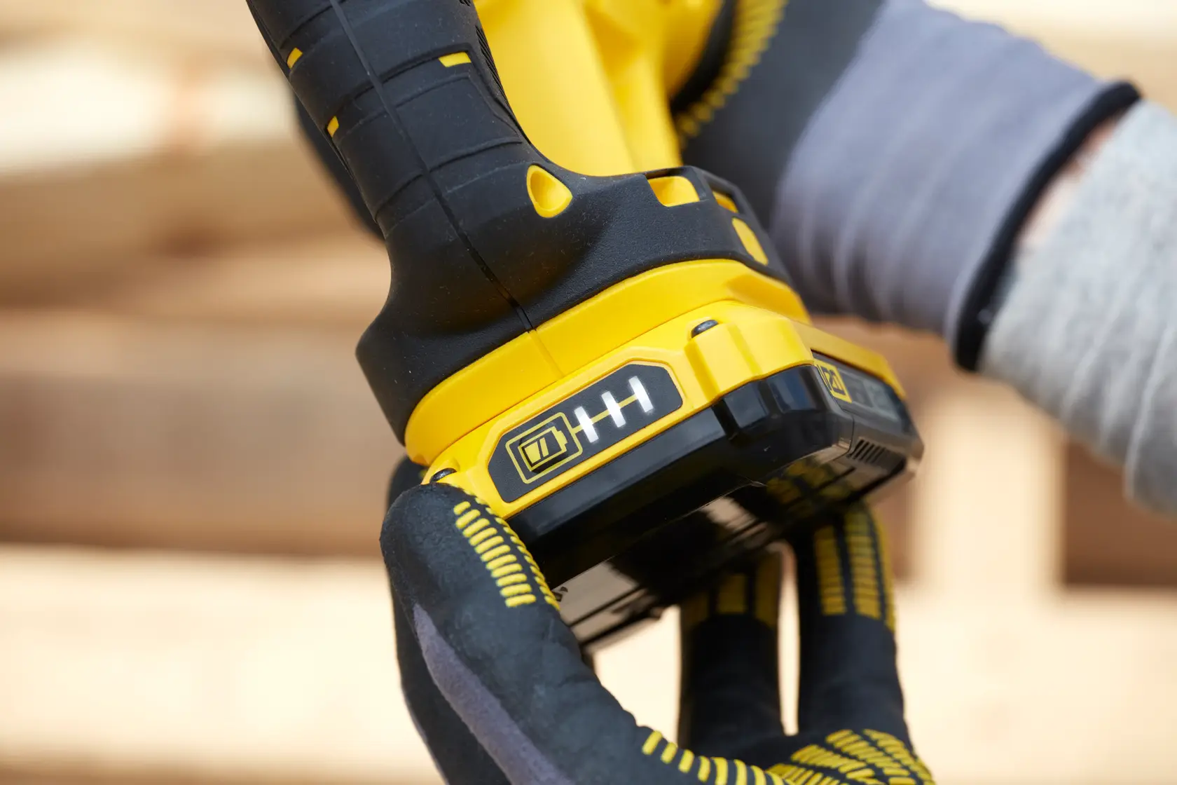 STANLEY SFMCS300D1K photography of cordless tool handle and battery held by gloved hand.