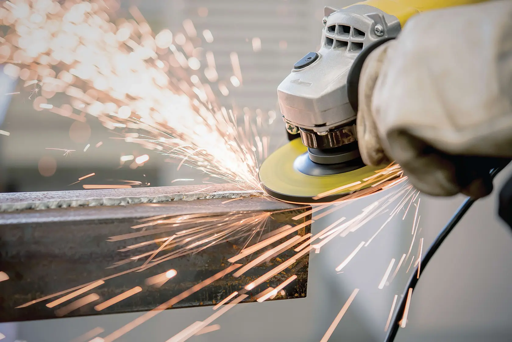STANLEY STA0413 angle grinder in use, close-up with sparks flying while grinding metal.