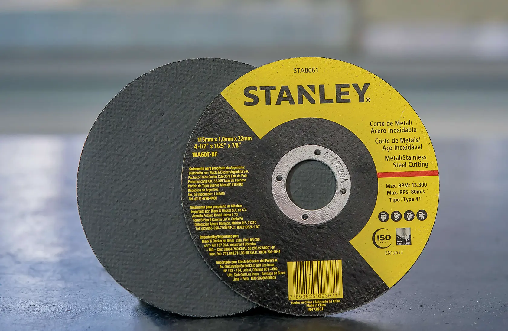 STANLEY STA8061 metal cutting disc with yellow label, 115mm size, steel and stainless steel use, side angle view.