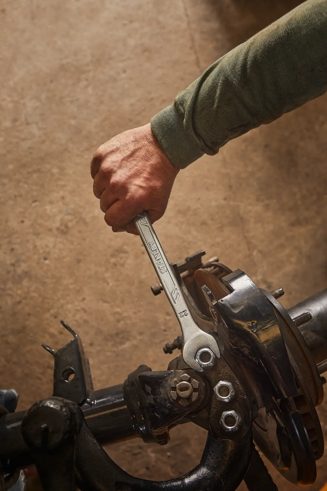 Stanley STMT72819 wrench in use on automotive part, close-up angle.