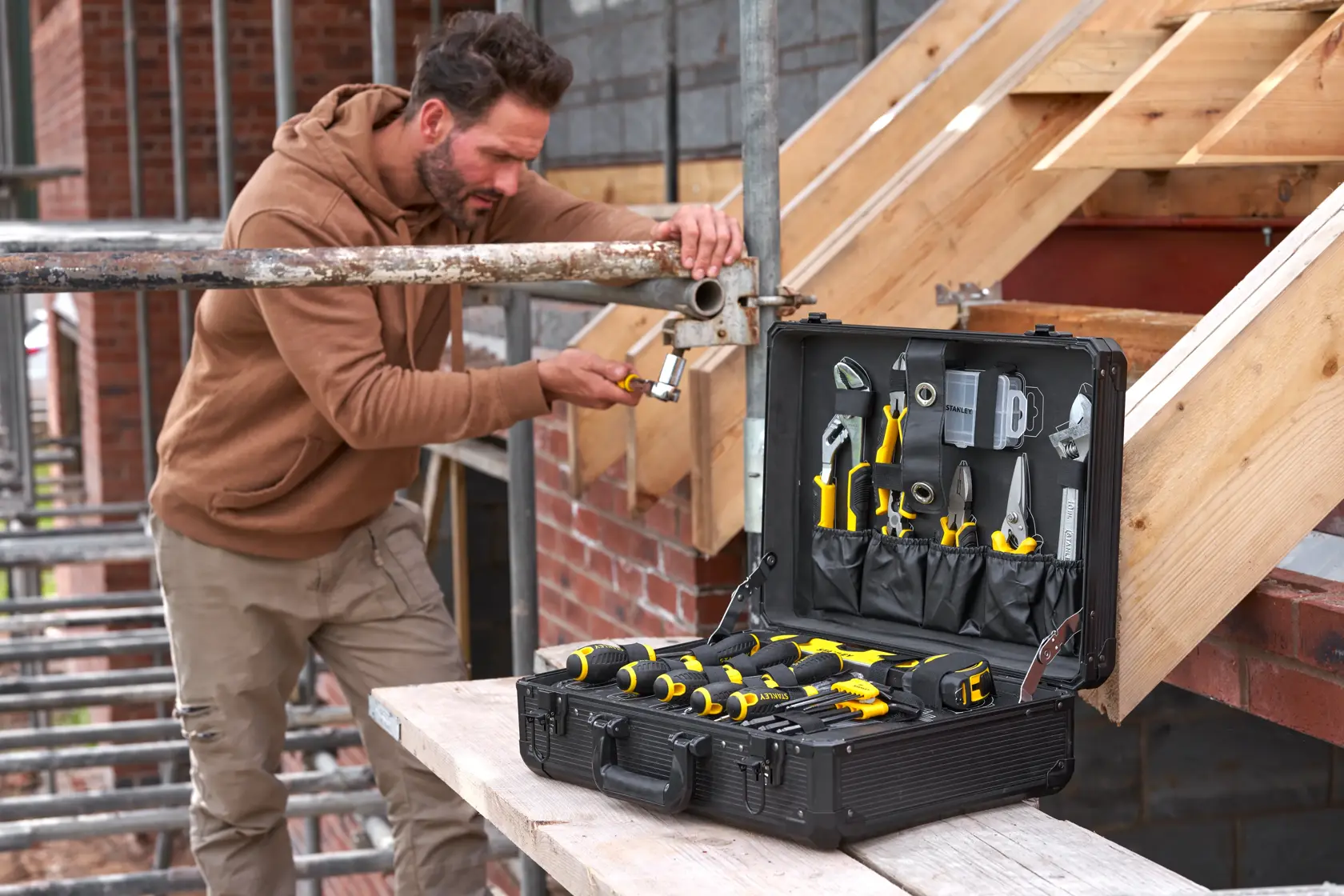 STANLEY STMT98109-1 maintenance suitcase with 142 tools, open on a construction site table.