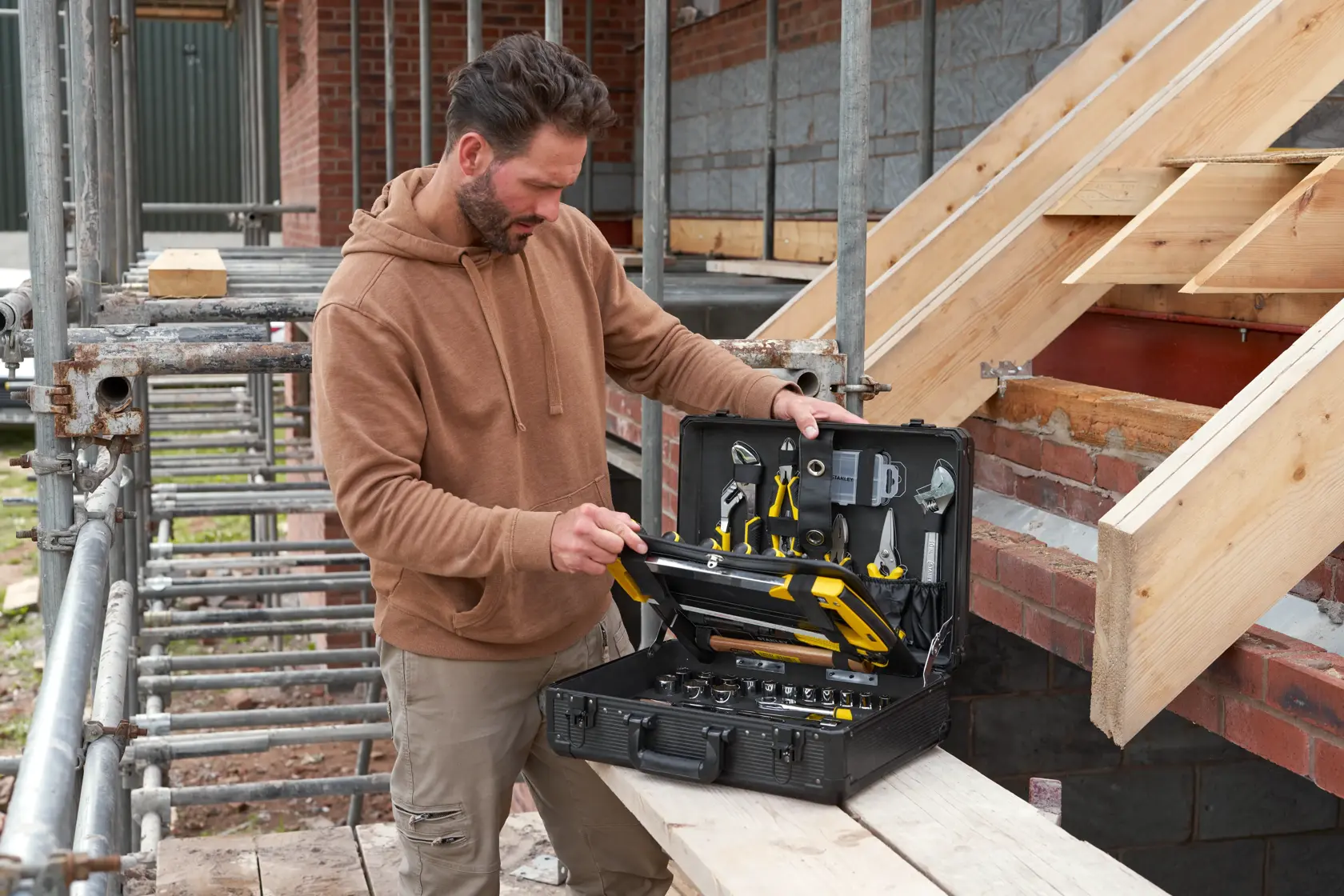 STANLEY STMT98109-1 maintenance suitcase with 142 tools open at construction site, showing organized tools.