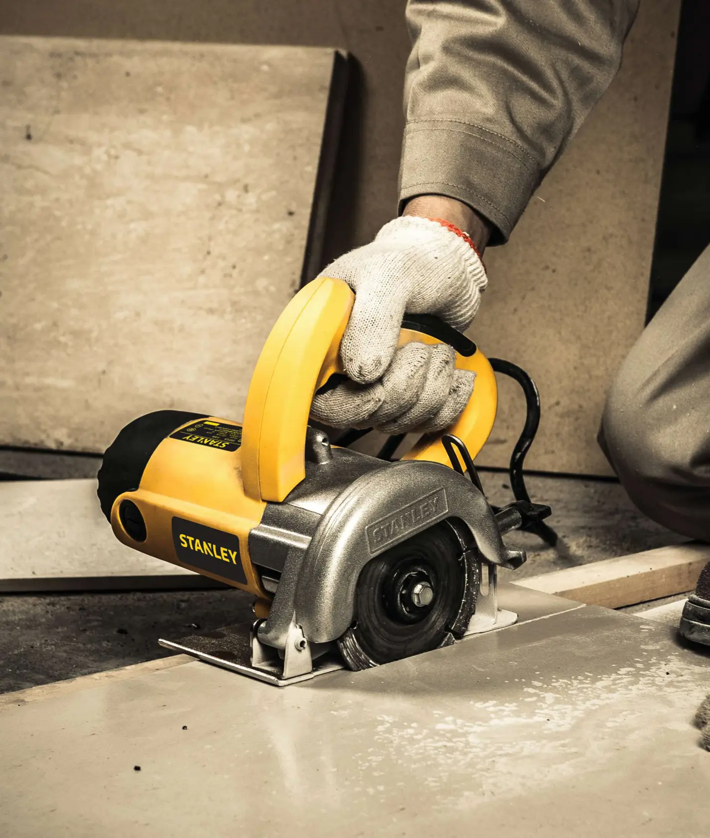 Stanley STSP125-KR tile cutting saw in use on tile surface, close-up photography.