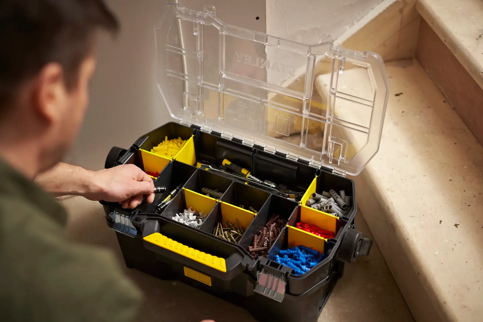 STANLEY STST1-70317 organizer box with yellow dividers and assorted hardware, photo at angled top view.