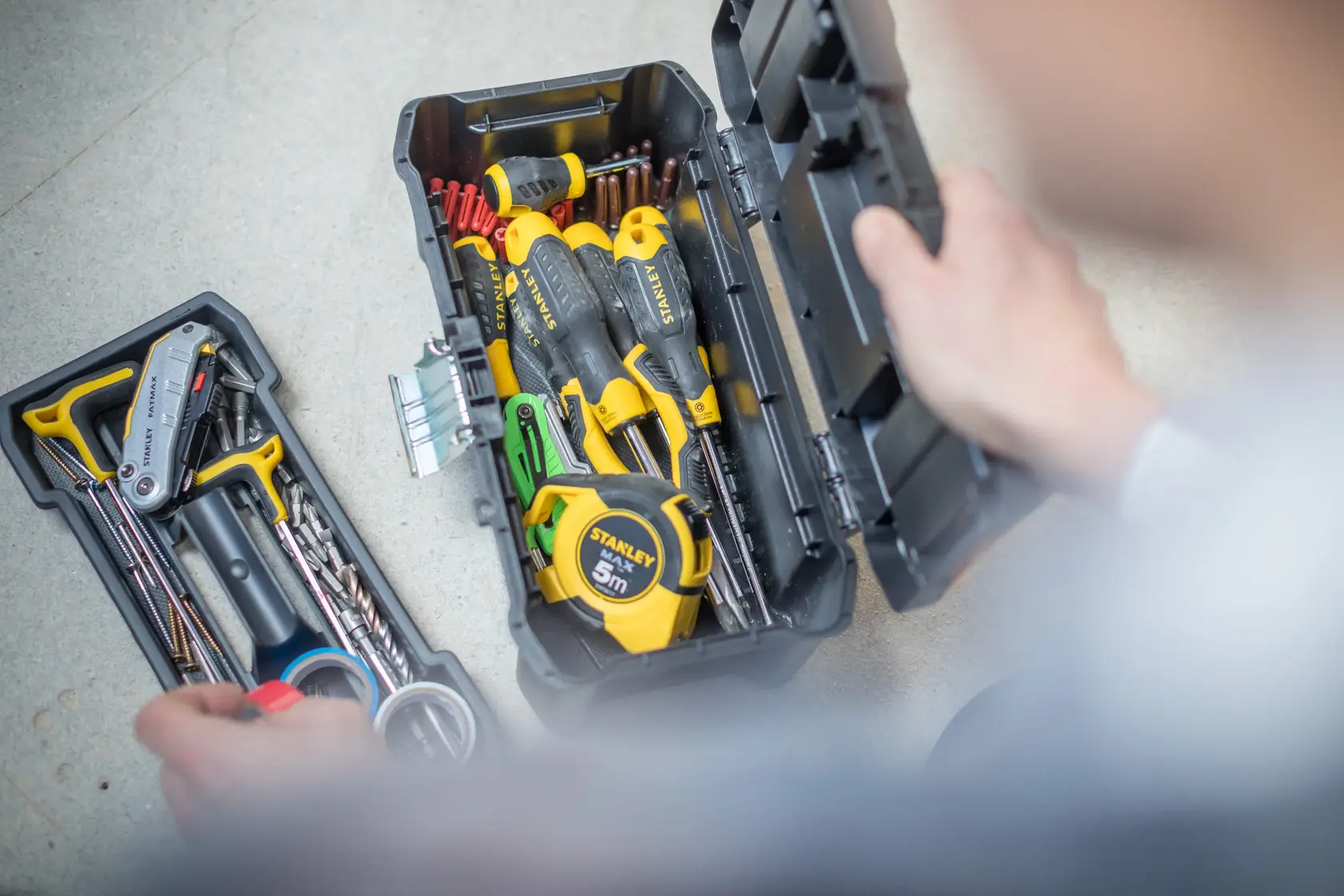 STANLEY tool box STST1-75515, STST1-75515-KR filled with hand tools, photo from above on light floor.