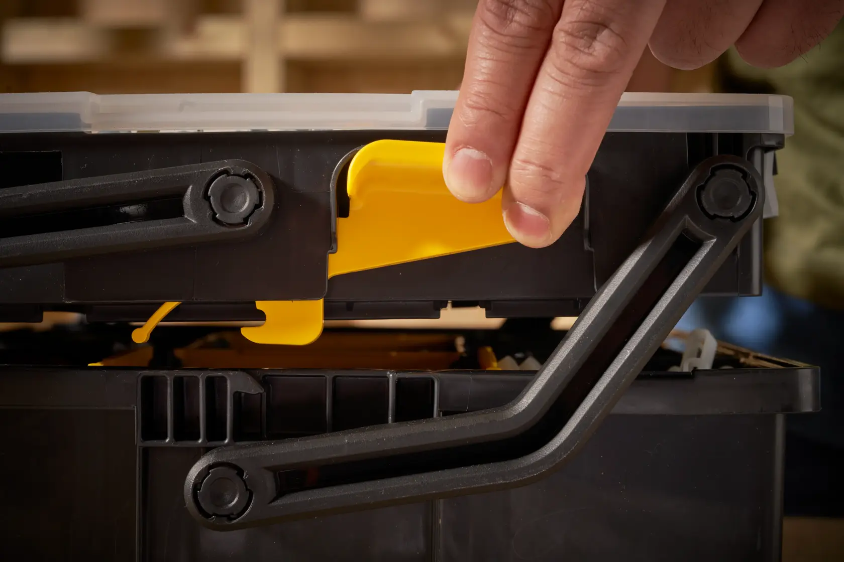STANLEY STST1-75540 toolbox close-up showing yellow latch being operated.