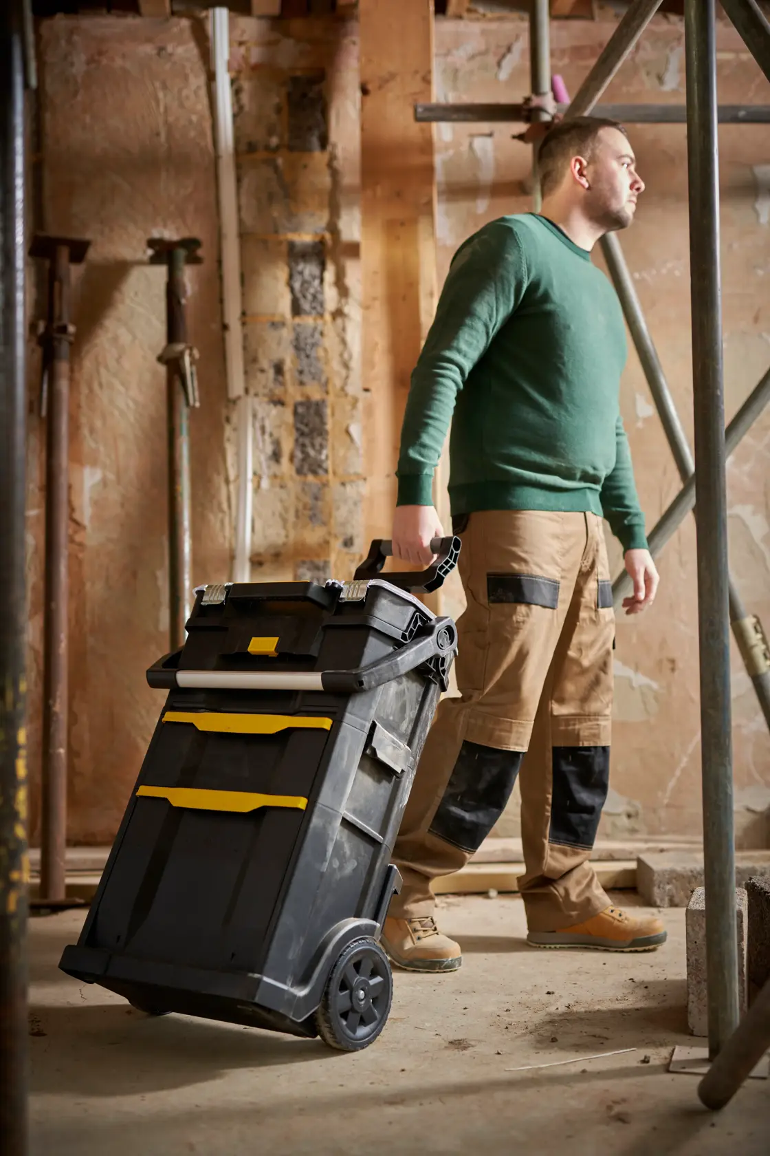 STANLEY STST1-79231 mobile tool chest with yellow accents, shown in use at a construction site.