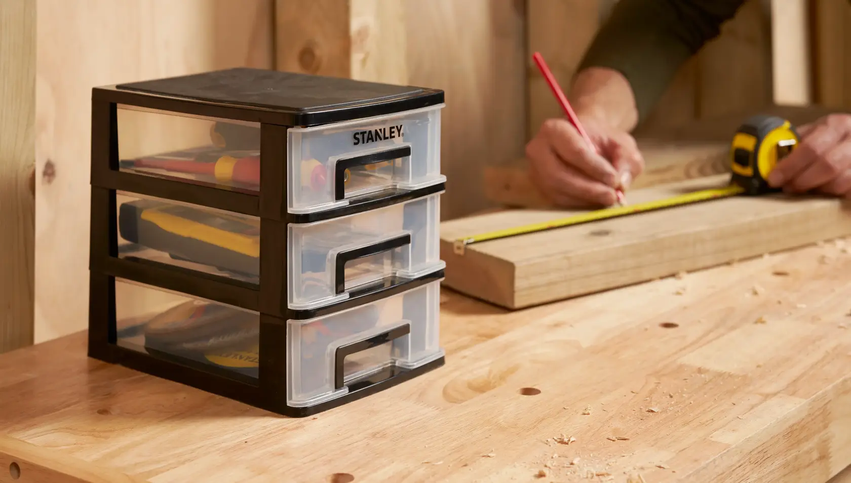 STANLEY STST40710-1 drawer organizer for tools on workbench, side view, workshop setting.